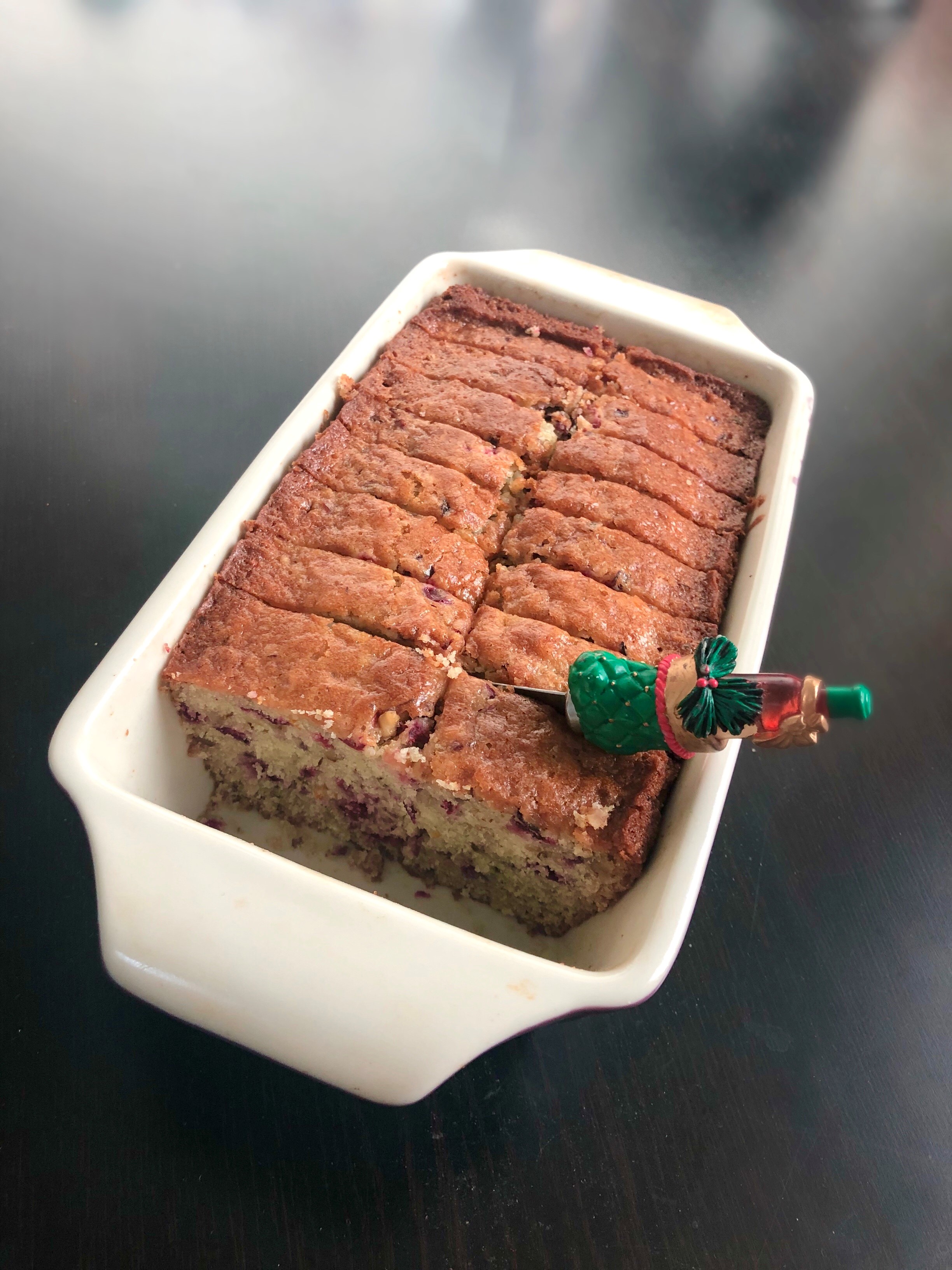 loaf of cranberry bread with a christmas knife